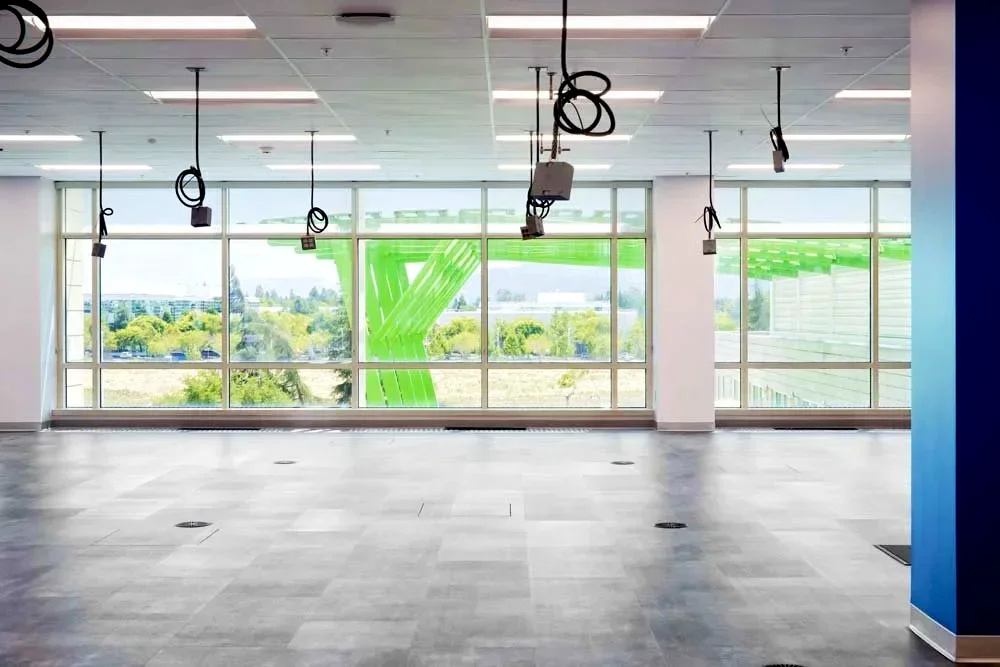 Open-plan office build-out with exposed ceiling and window wall