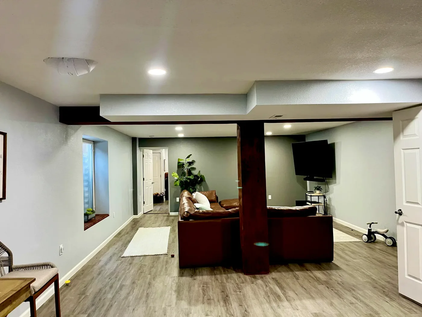 Finished basement with recessed lighting and a lit soffit