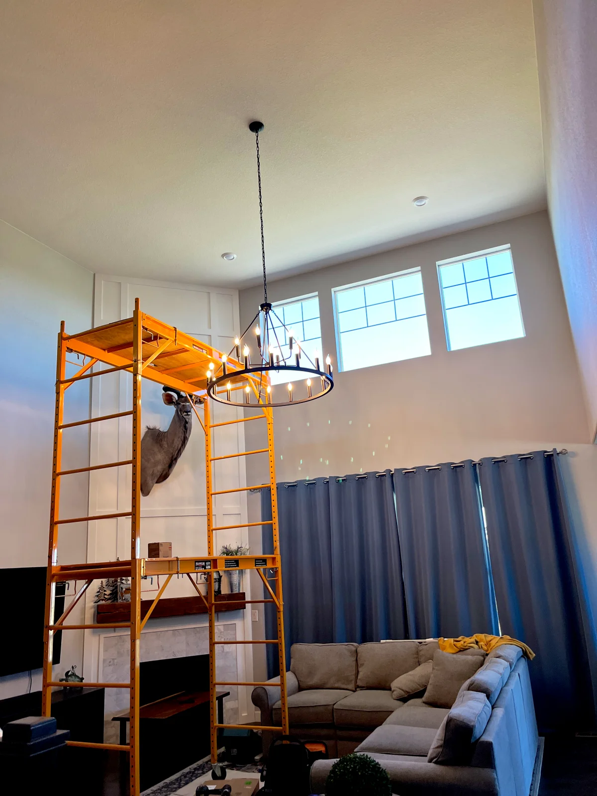 Scaffolding set up under a great room ceiling to hang a chandelier