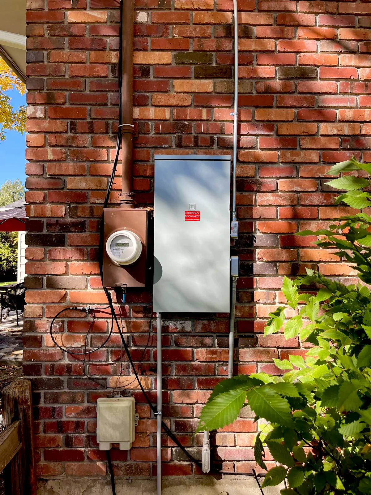 Exterior electrical meter and emergency disconnect on a brick wall